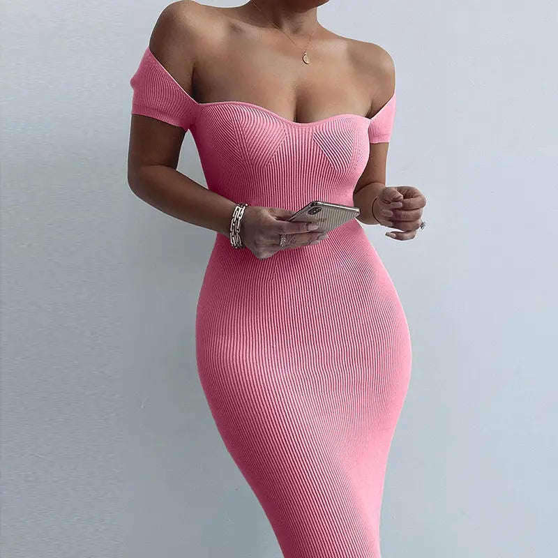 Person wearing a pink off-shoulder dress against a light gray background